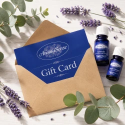 AromaSense gift card in a kraft envelope with lavender sprigs, eucalyptus leaves and essential oil bottles.